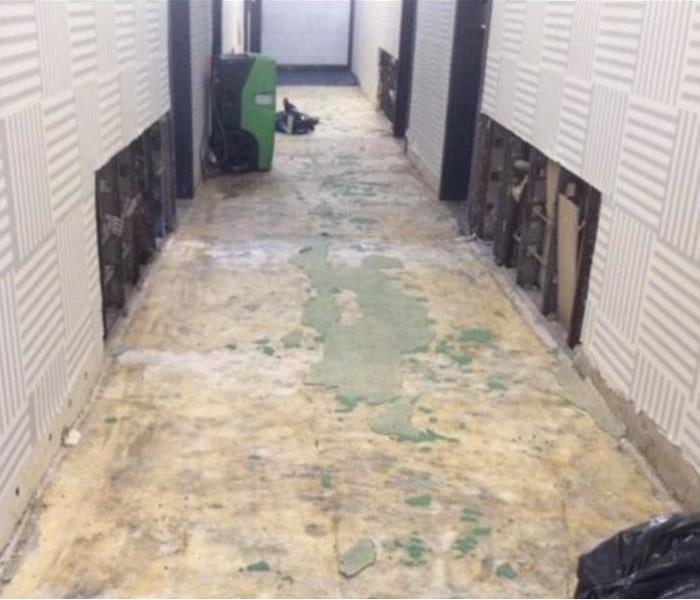 long hallway, a dehumidifier, flood cuts performed on drywall